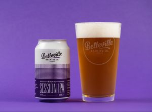 Christmas Beer and Food Pairings. Photograph of a can of Belleville Picnic Session IPA and a glass of amber coloured beer on a purple background