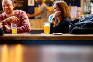 Christmas Beer and Food Pairings. Photograph of a couple drinking beer in the Belleville Taproom