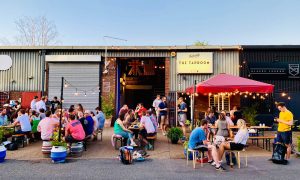 Deep Dive into Picnic Session IPA. Photograph of The Belleville Brewery Taproom in Summer with people and tables outside