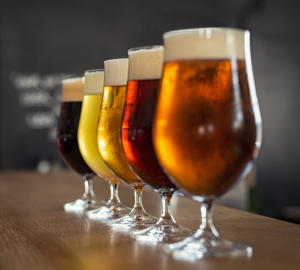 How to drink beer like a pro? Photograph of five tulip shaped glasses filled with different coloured beer