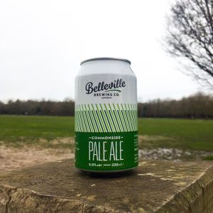 Deep Dive Into Commonside Pale Ale. Photograph of a can of Comonside Pale Ale with a grassy Wandsworth Common in the background.